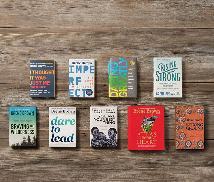 A dark wood table displaying Brené's books