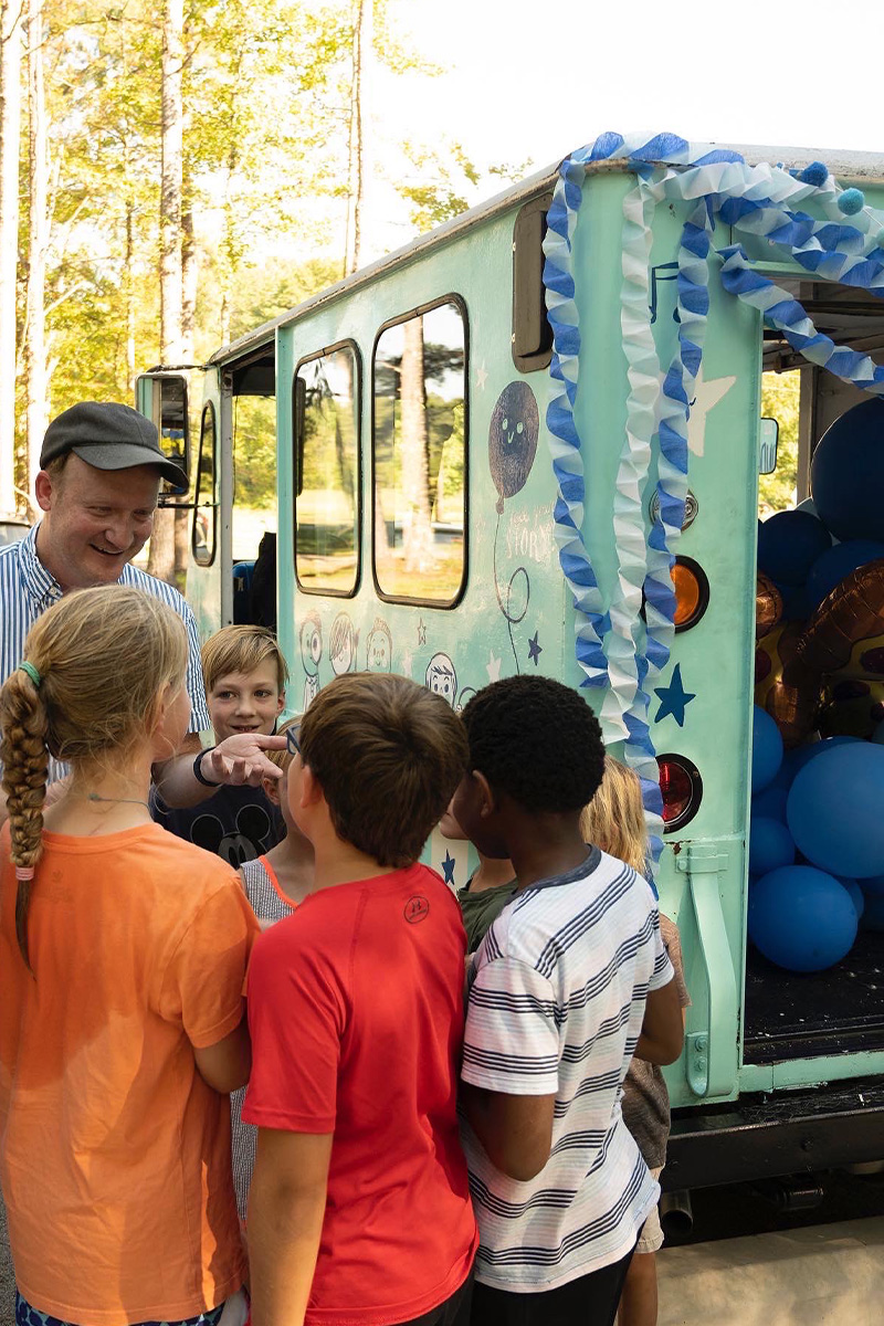 Brad with some young friends, sharing stories about creativity and compassion from his traveling “Wonder Truck”