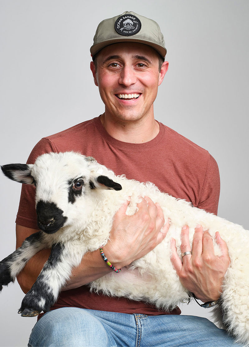 Randal is pictured holding Kotton the Swiss Lamb.