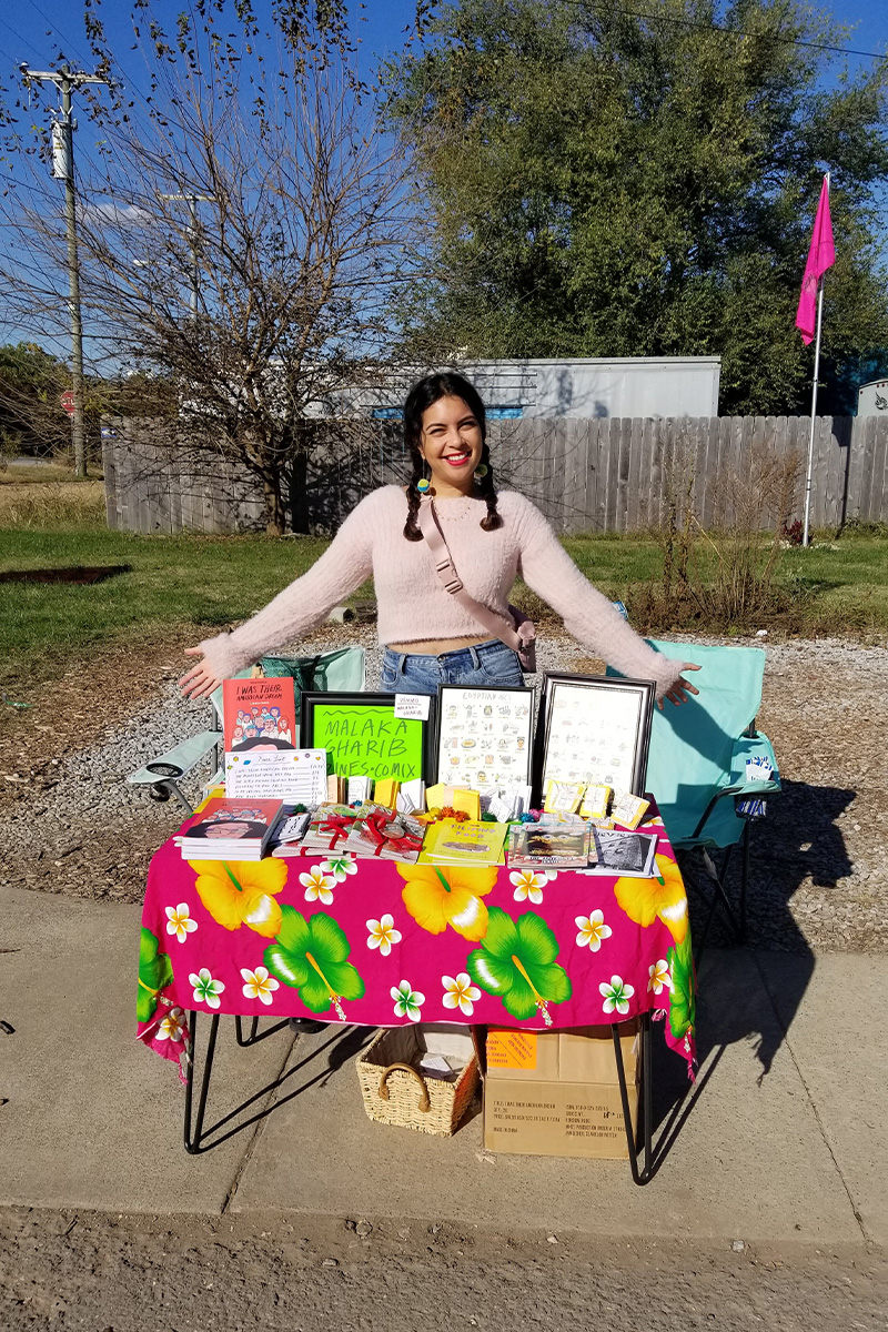 Malaka tabling at a Nashville zine fest in 2021.