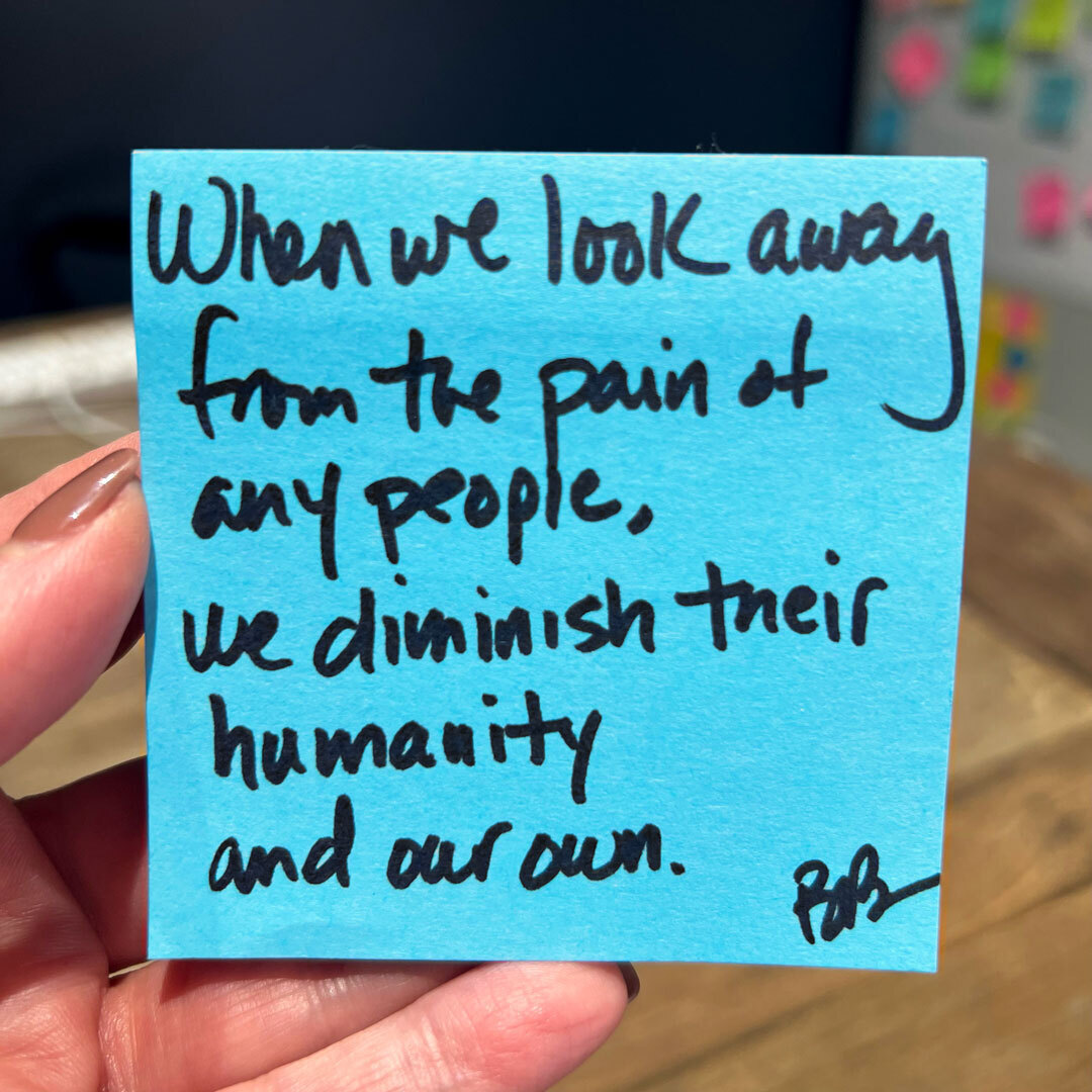 A quote from Brené on a blue sticky note: “When we look away from the pain of any people, we diminish their humanity and our own.”