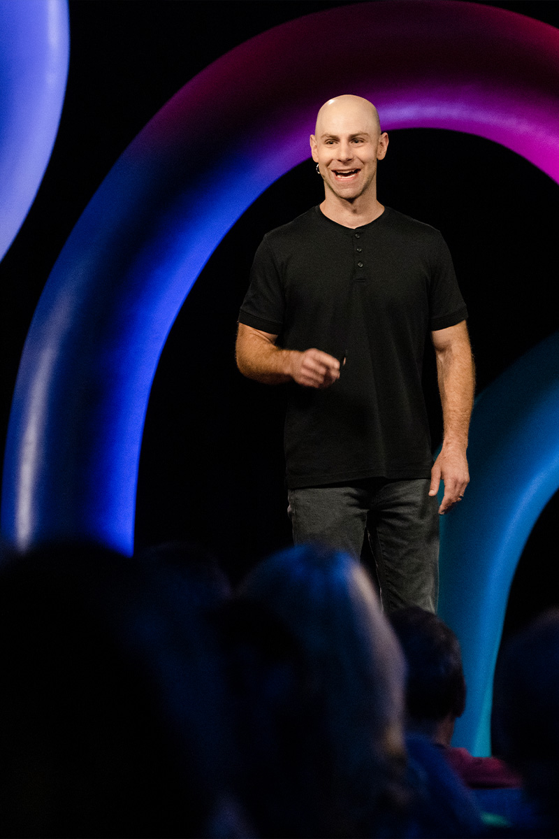 Adam on stage at TED