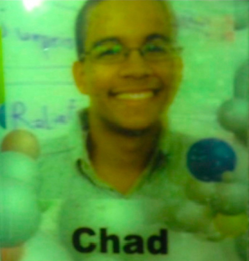 A Google ID card featuring a younger Chad Sanders, smiling, wearing glasses and a button down shirt.