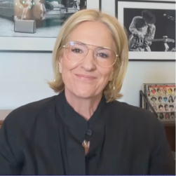 Brené Brown smiling in a black shirt on the Katie Couric podcast